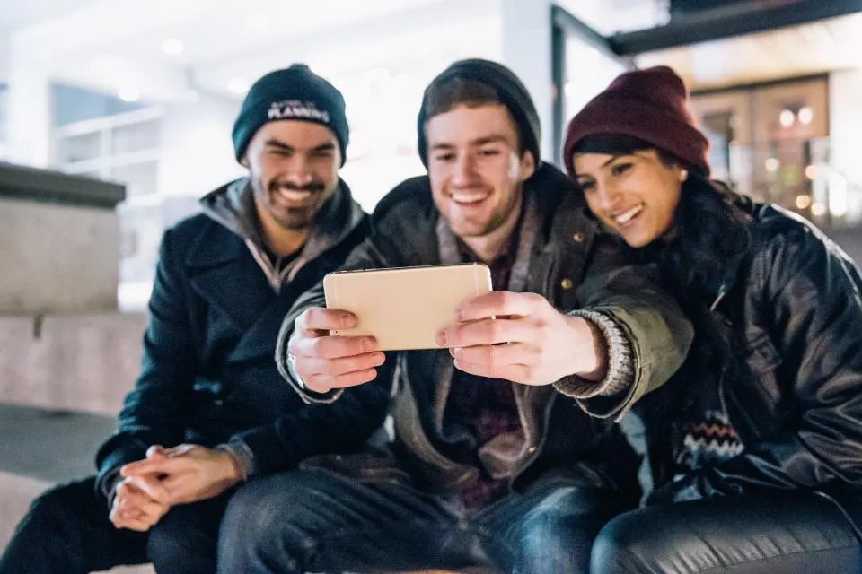 Three friends taking a selfie together
